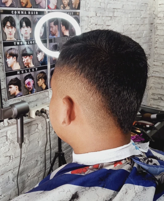 Barber cutting hair with precision scissors